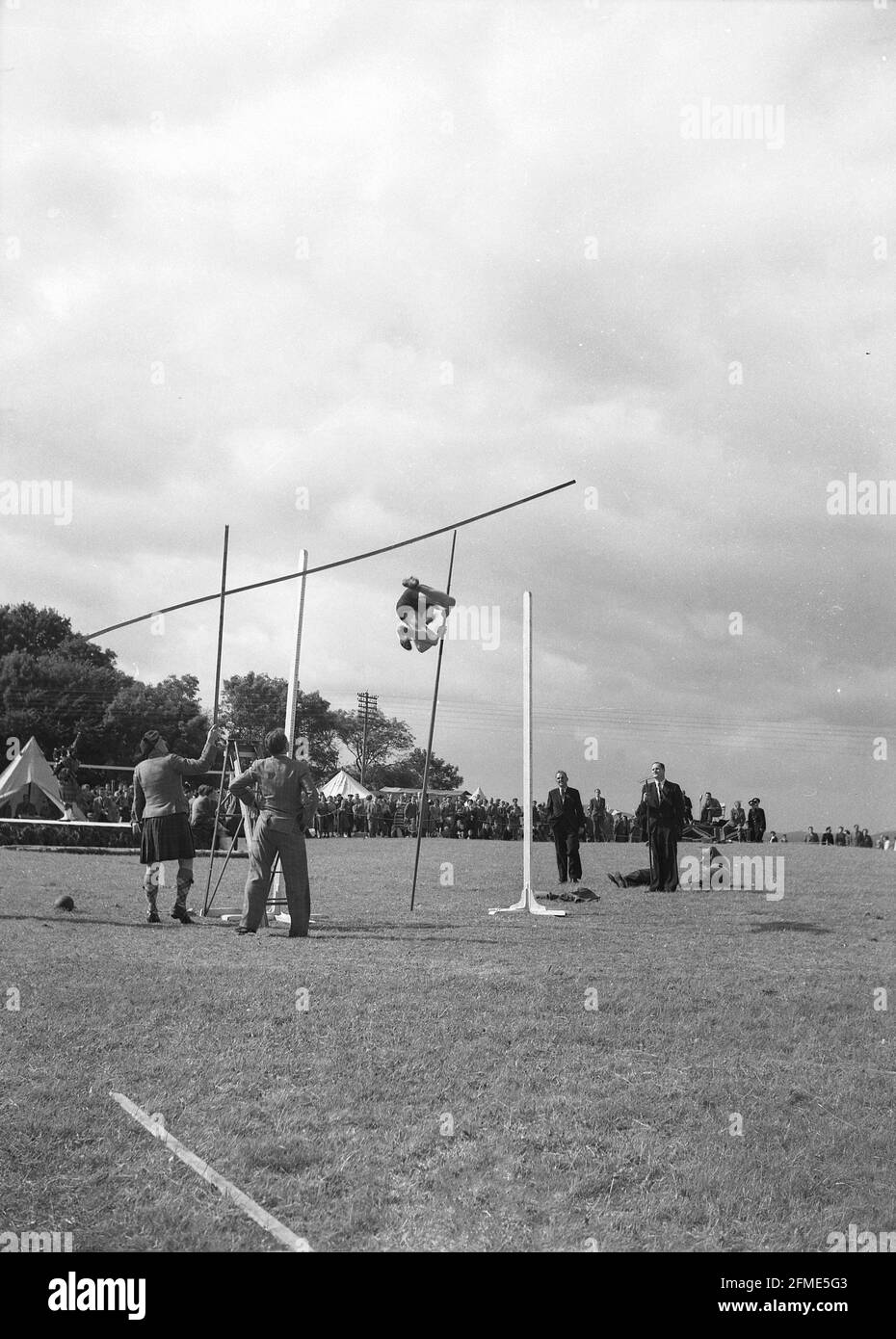 1956, historical, at a highland games, a male competitor taking part in a Scottish version on the pole vault, Scotland, UK. The first modern Highland games was held in Inverness in 1822, organised by The Northern Meeting Society. Stock Photo