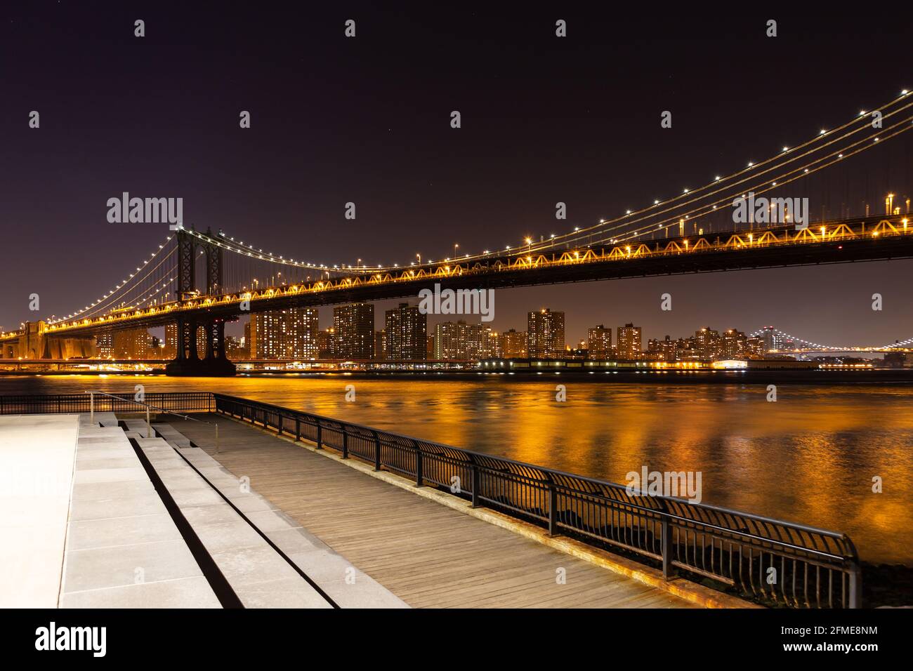 Manhattan Bridge from Brooklyn to Manhattan at night, with a viewing platform on Brooklyn side. Stock Photo