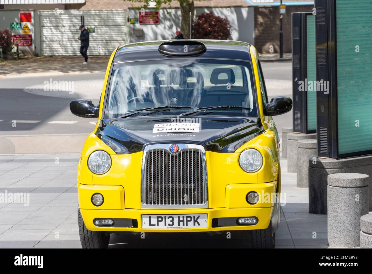 Yellow and black London cab at Imperial Wharf, Chelsea Harbour, Sands End, Borough of Hammersmith and Fulham, Greater London, England, United Kingdom Stock Photo