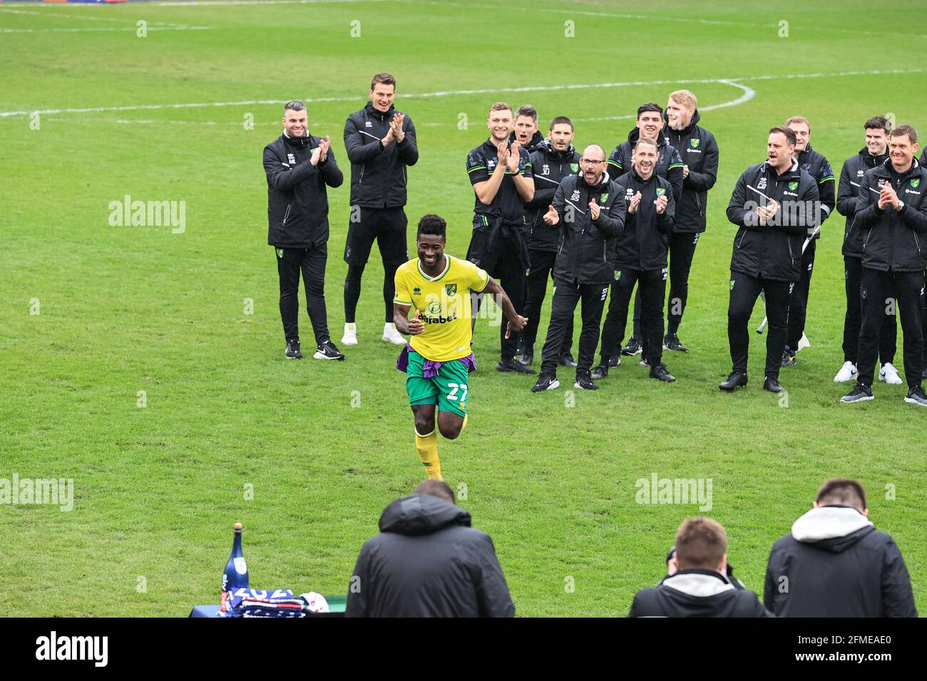 Alexander Tettey #27 of Norwich City runs up to revive his league winners medal Stock Photo