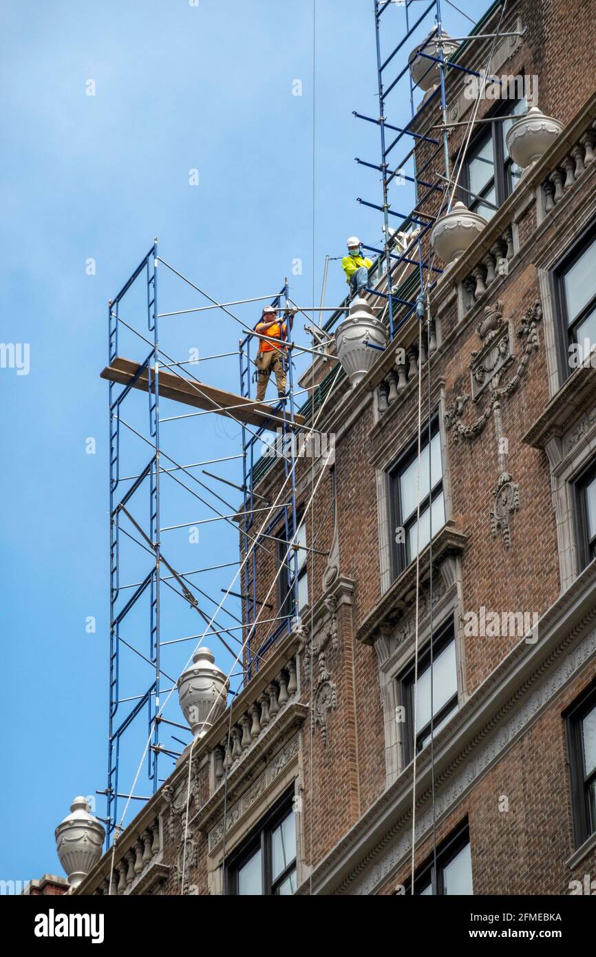 rConstruction Worker on a High-Rise Building Scaffolding, NYC, USA Stock Photo