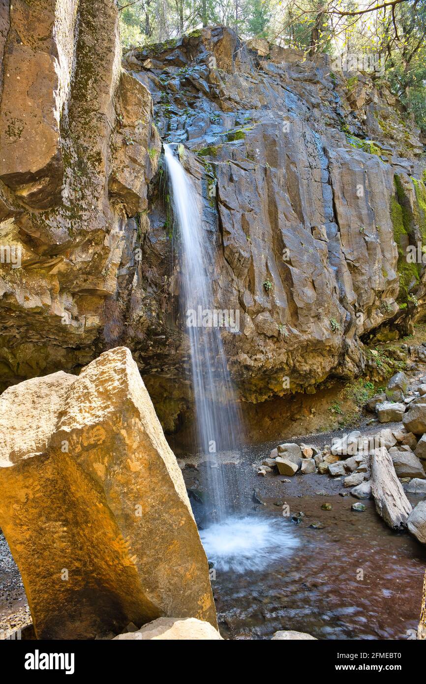 Vertical shot of a wild rocky waterfall on a sunny day Stock Photo - Alamy