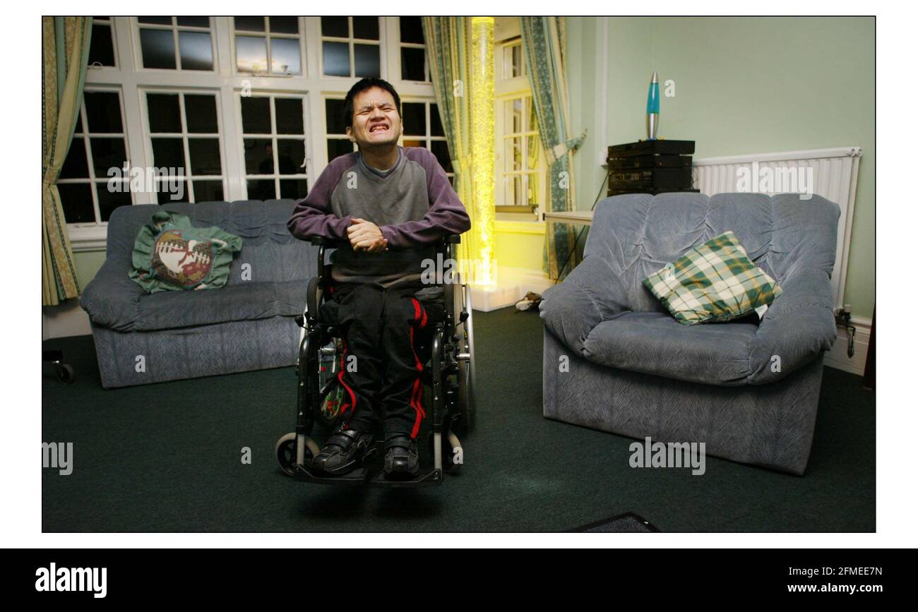 CHRISTMAS APPEAL..........Ockenden International supports Kilmore House in Camberly, Surrey, where some of the 1975 vietnam refugees with learning difficulties live.  Ha Nguyen Van smiles for the camera posing in the lounge.pic David Sandison 10/12/2003 Stock Photo