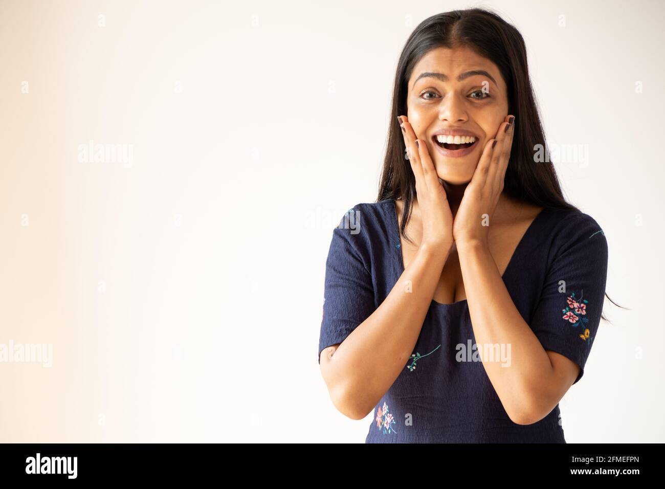 Closeup shot of an excited Asian girl on a white background Stock Photo ...