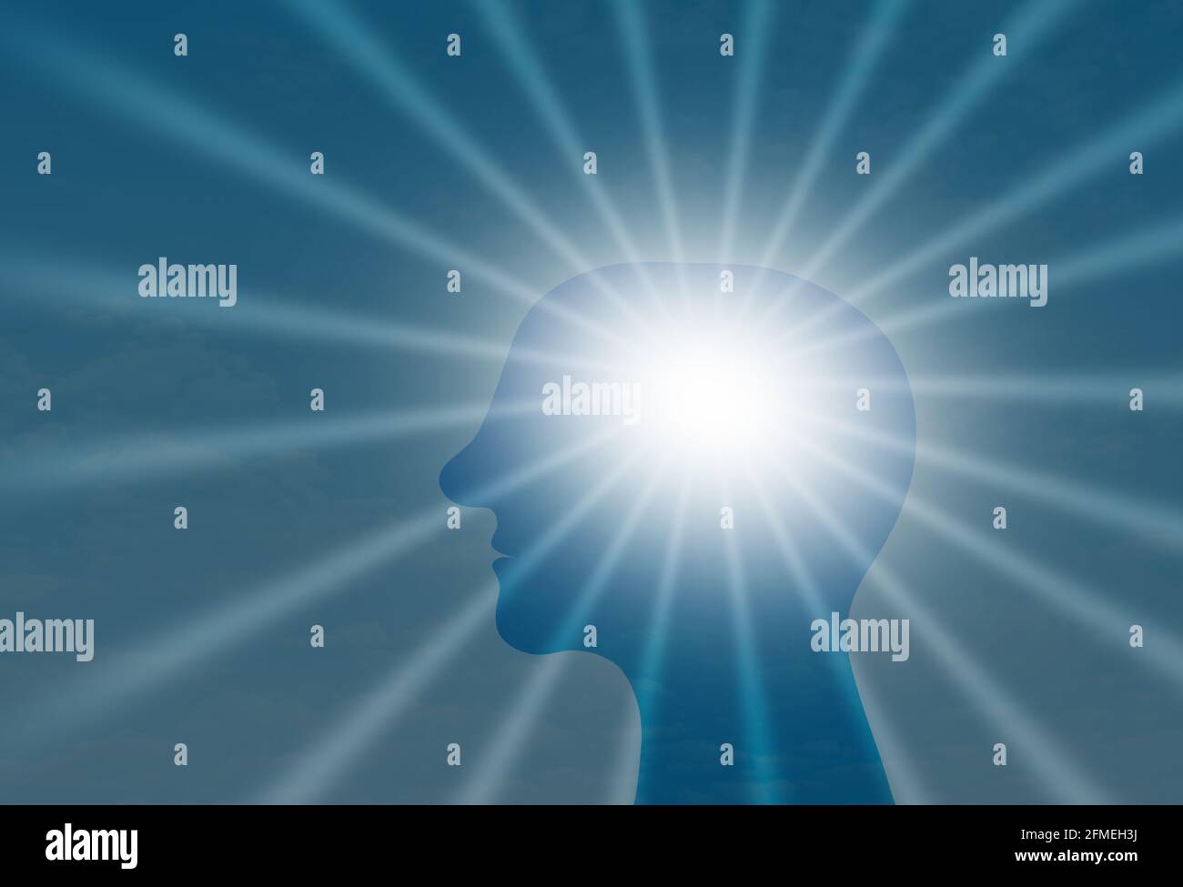 Man head Shiltuette In front of sun rays in blue sky, Brain positive energy Concept Stock Photo