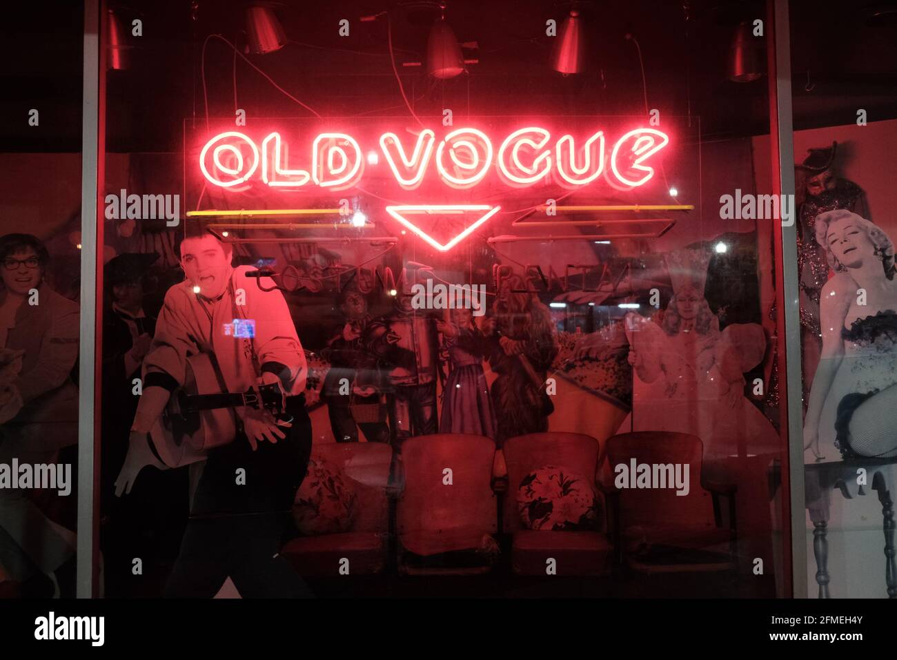 This is a photograph of a neon sign in downtown Lafayette Louisiana that says "Old Vogue". There