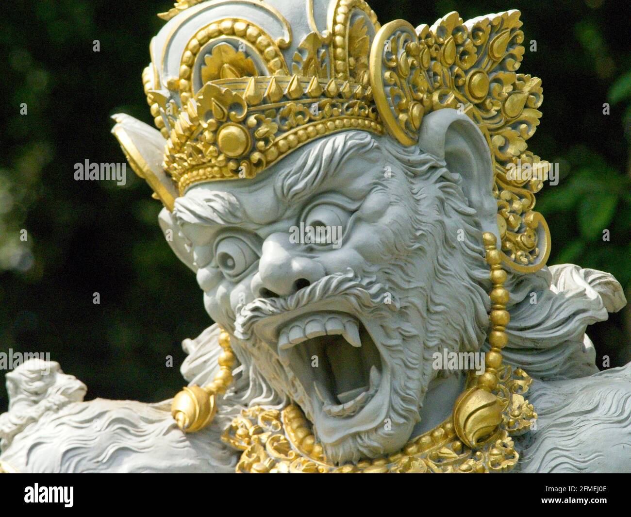 Closeup of golden Balinese mythology statue with scary face Bali, Indonesia. Stock Photo