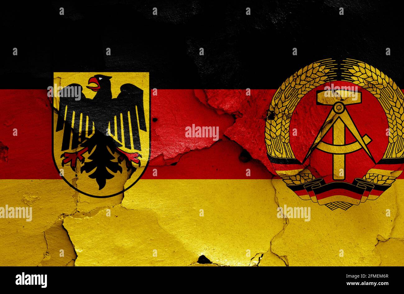 historical flags of West Germany and East Germany painted on cracked wall Stock Photo