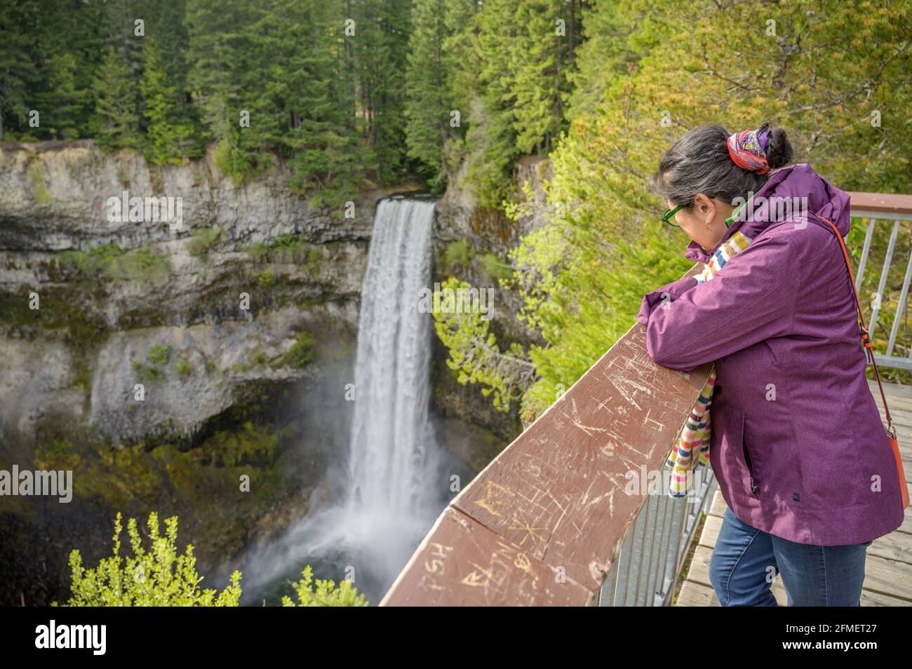 A woman watches over Brandywine Falls from the viewing platform at at