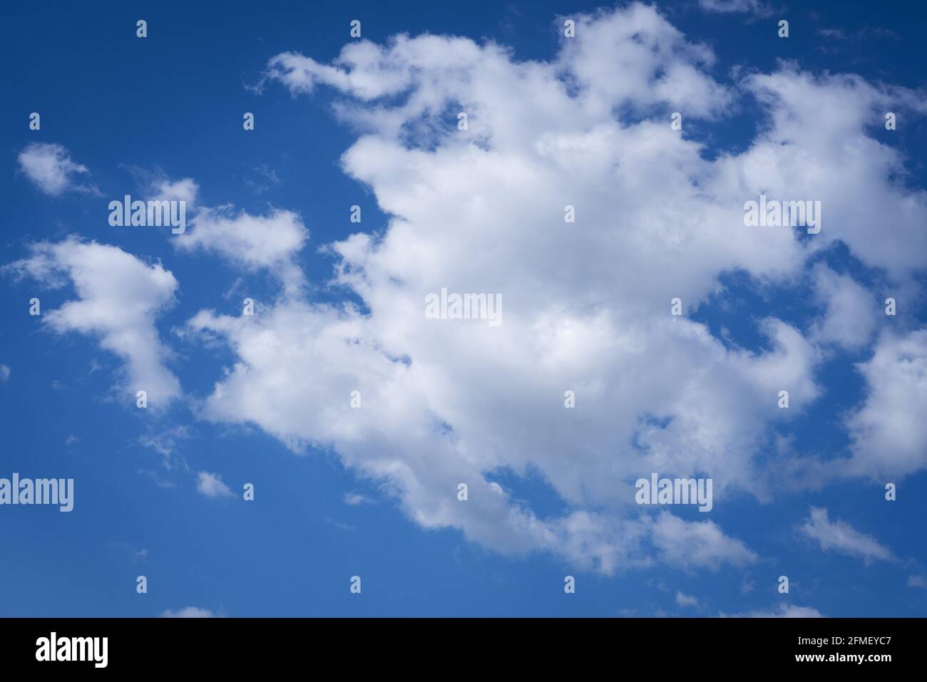 big white clouds in blue sky as background Stock Photo - Alamy