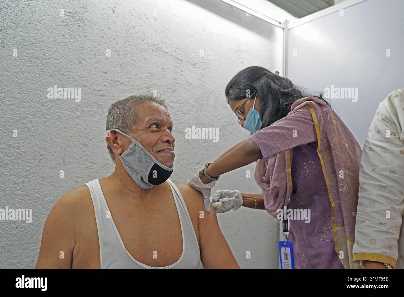 First Drive-In Vaccination Center Old Man gets vaccinated with COVID-19 Covishield vaccine manufactured by Serum Institute of India at Mumbai 2021 Stock Photo