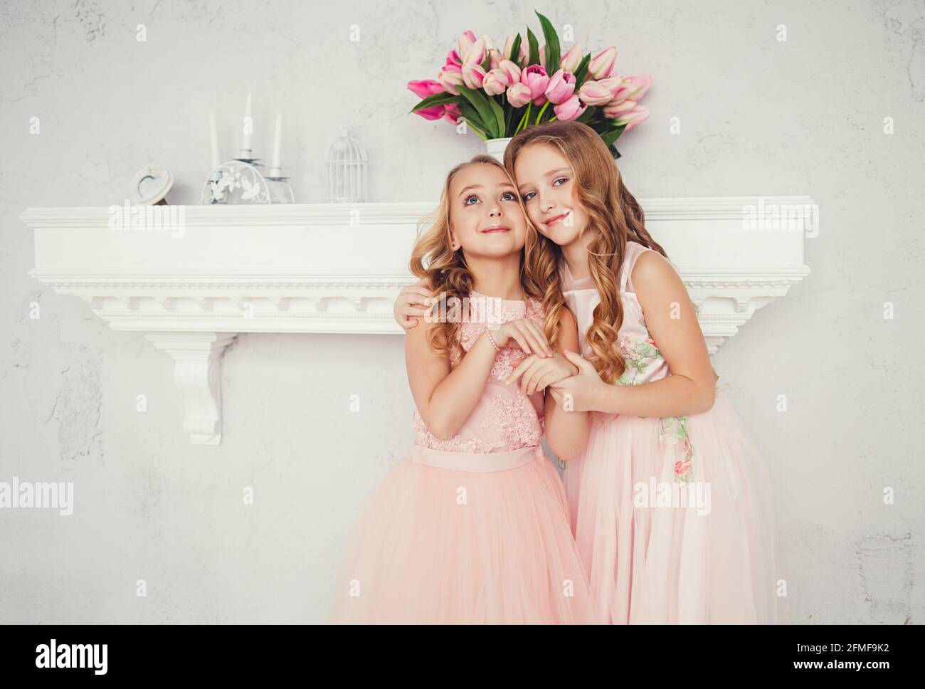 portrait of two embracing cute little girls in dresses Stock Photo - Alamy