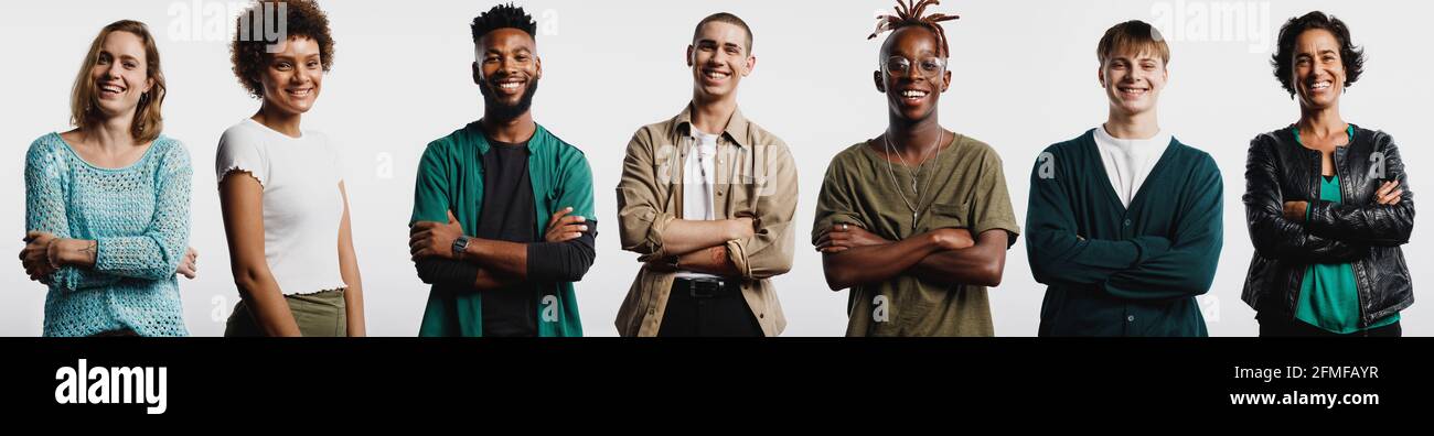 Happy multiethnic men and women standing together. Smiling young people ...