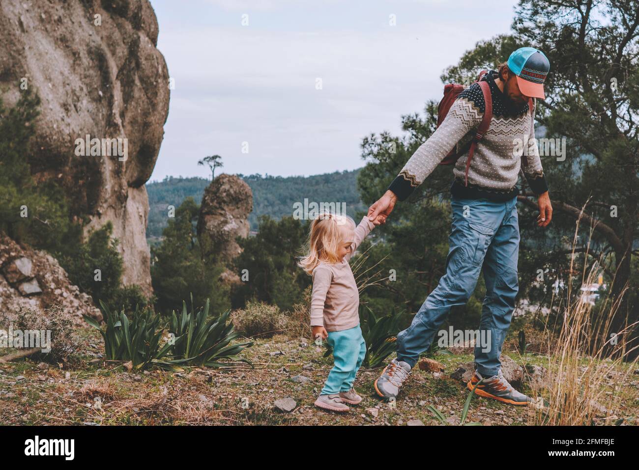 Father and daughter child hiking outdoor together in mountains family travel lifestyle active vacation tour Stock Photo