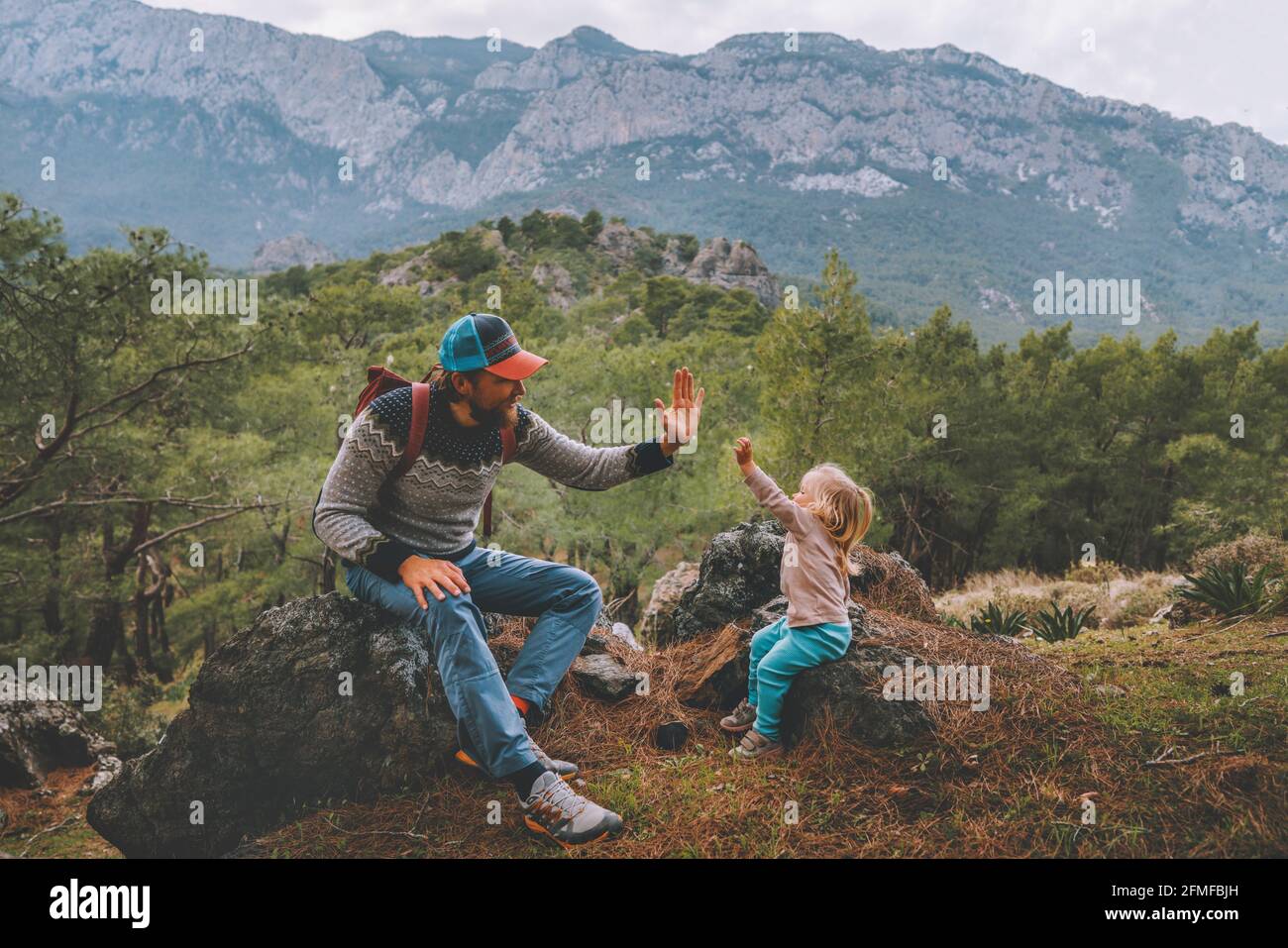Family father and child daughter high five hands traveling in mountains hiking together summer vacation adventure lifestyle outdoor Lycian way in Turk Stock Photo