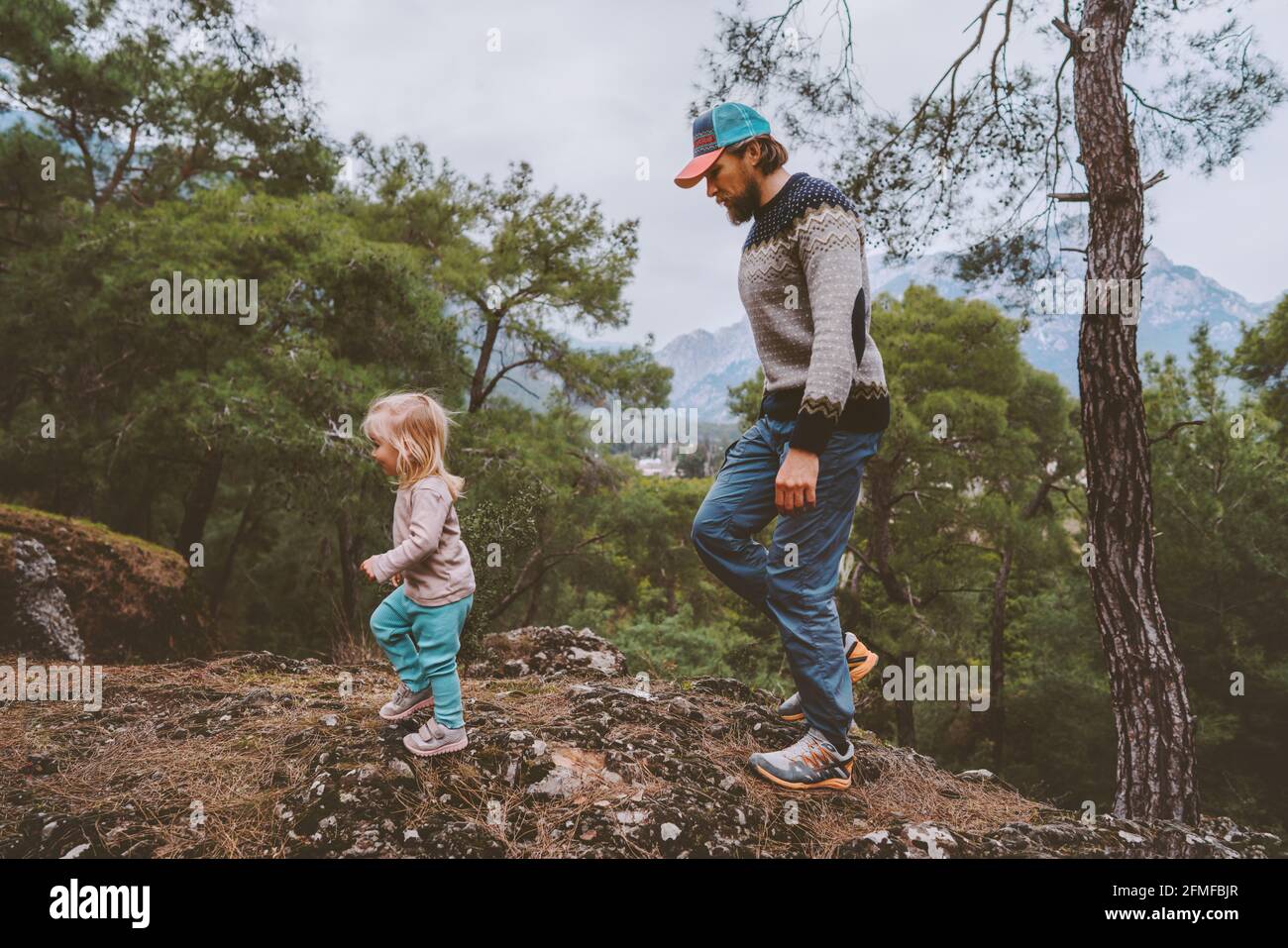 Father and child daughter traveling hiking together family vacation adventure lifestyle outdoor in forest Stock Photo