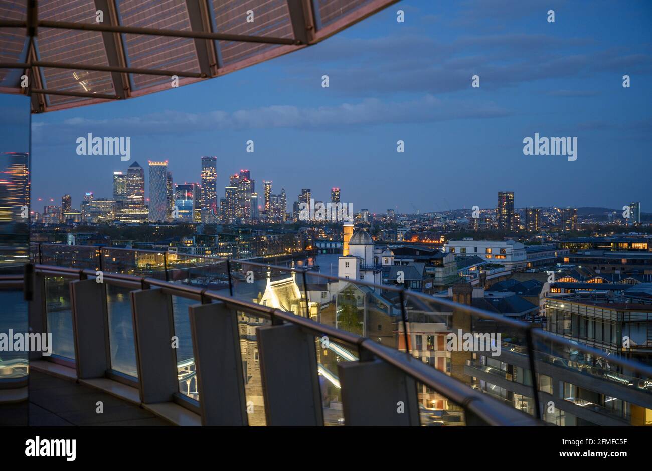 View of Canary Wharf skyscrapers from the top floor balcony of City Hall in London during London Mayor election results night. Stock Photo