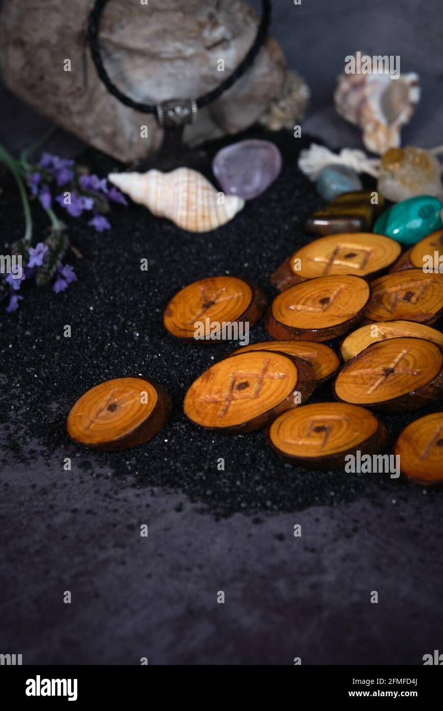 homemade wooden runes on a dark background Stock Photo - Alamy