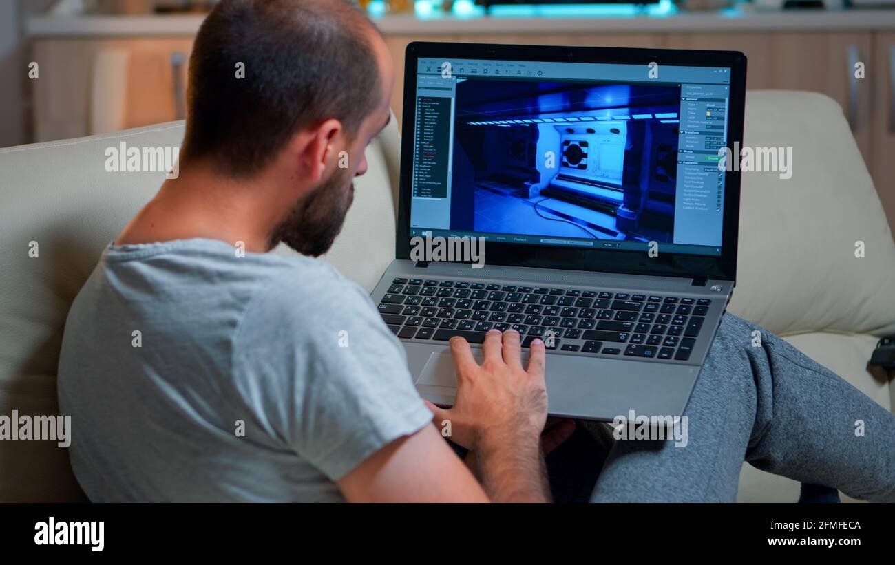 Caucasian game developer working on gameplay and game level late at ...