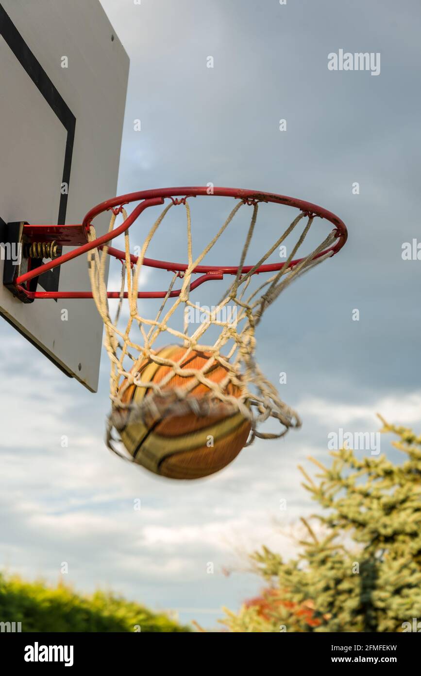 Basketball going through hoop. Goal! Stock Photo Alamy