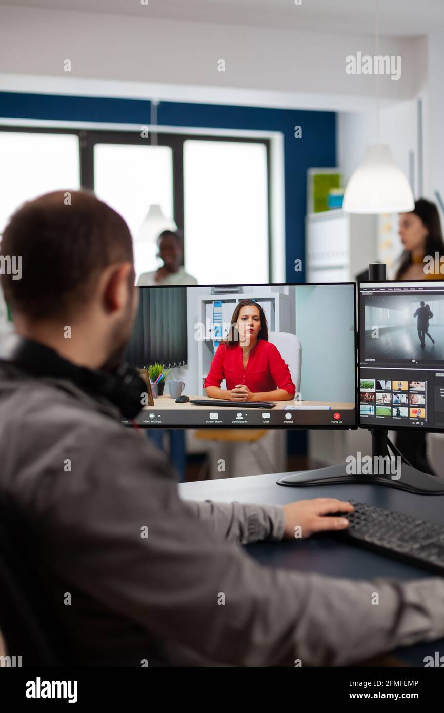 Video editor talking with remote customer in web online meeting using