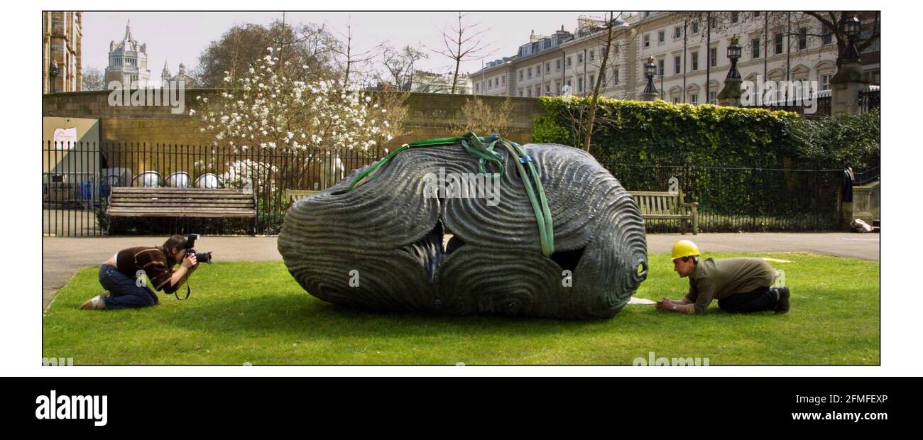 18 Tonnes of granite glacial boulder and bronze art, by British sculptor Peter Randall-Page was delivered to the Natural History Museums west lawn. The exhibition marks the start of Spring. The artist on right being photographed with Bronze Dreaming Stone.pic David Sandison 27/3/2003 Stock Photo