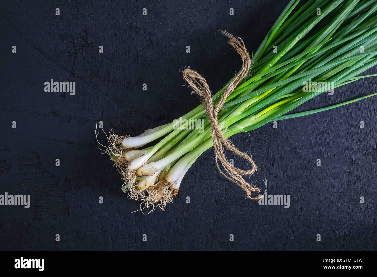 Bunch green onions on black hi-res stock photography and images - Alamy