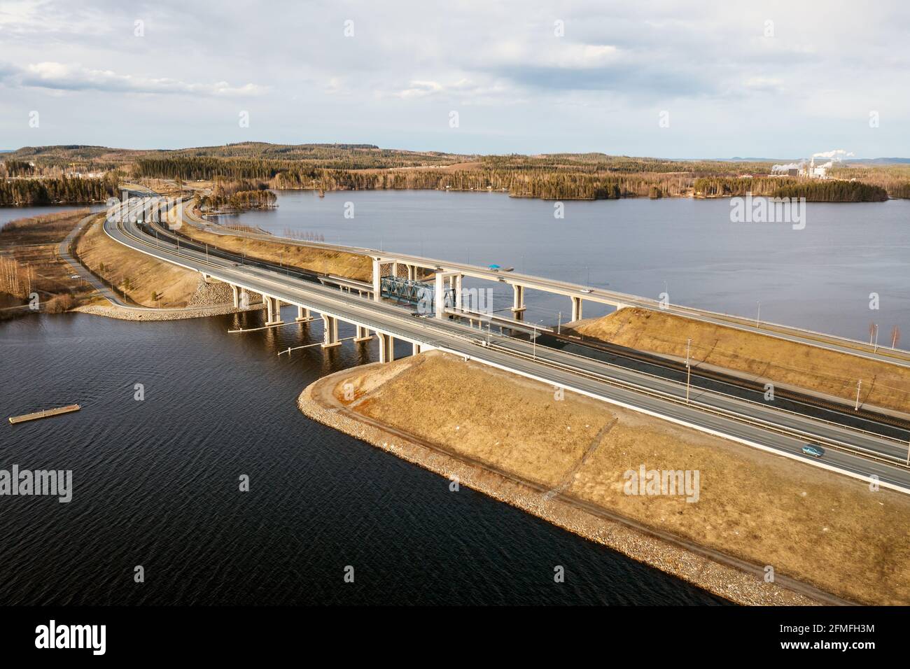 Motorway, railway and road bridges in a lake landscape north of Kuopio in eastern Finland in the spring sunshine. Stock Photo