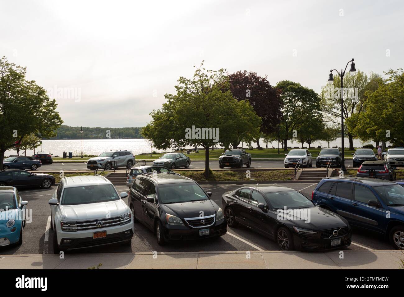 car park in front of the Dobbs Ferry Metro North train station in upstate New York with the Hudson River in the background, a small commuter town Stock Photo
