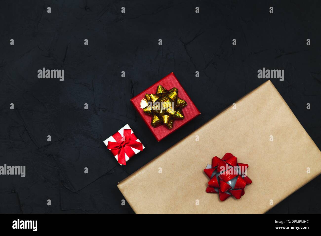 Gift boxes on a dark background. Flat lay, low key. Stock Photo