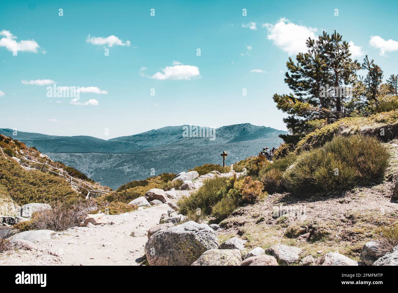 Trail on a mountain with signpost. Extreme long shot. Stock Photo
