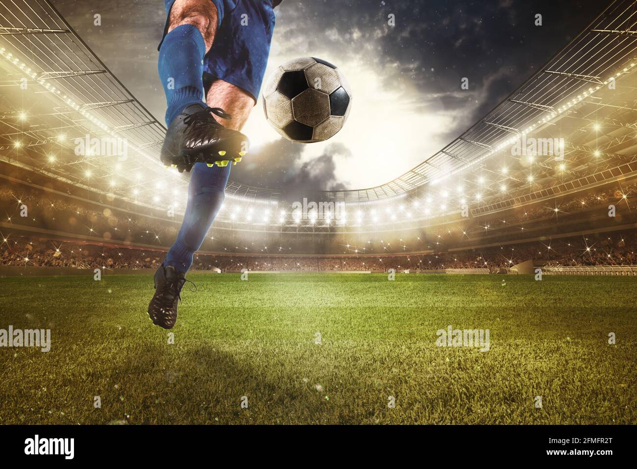 Close up of a striker who kicks the ball to make goals at the stadium during a soccer game Stock Photo