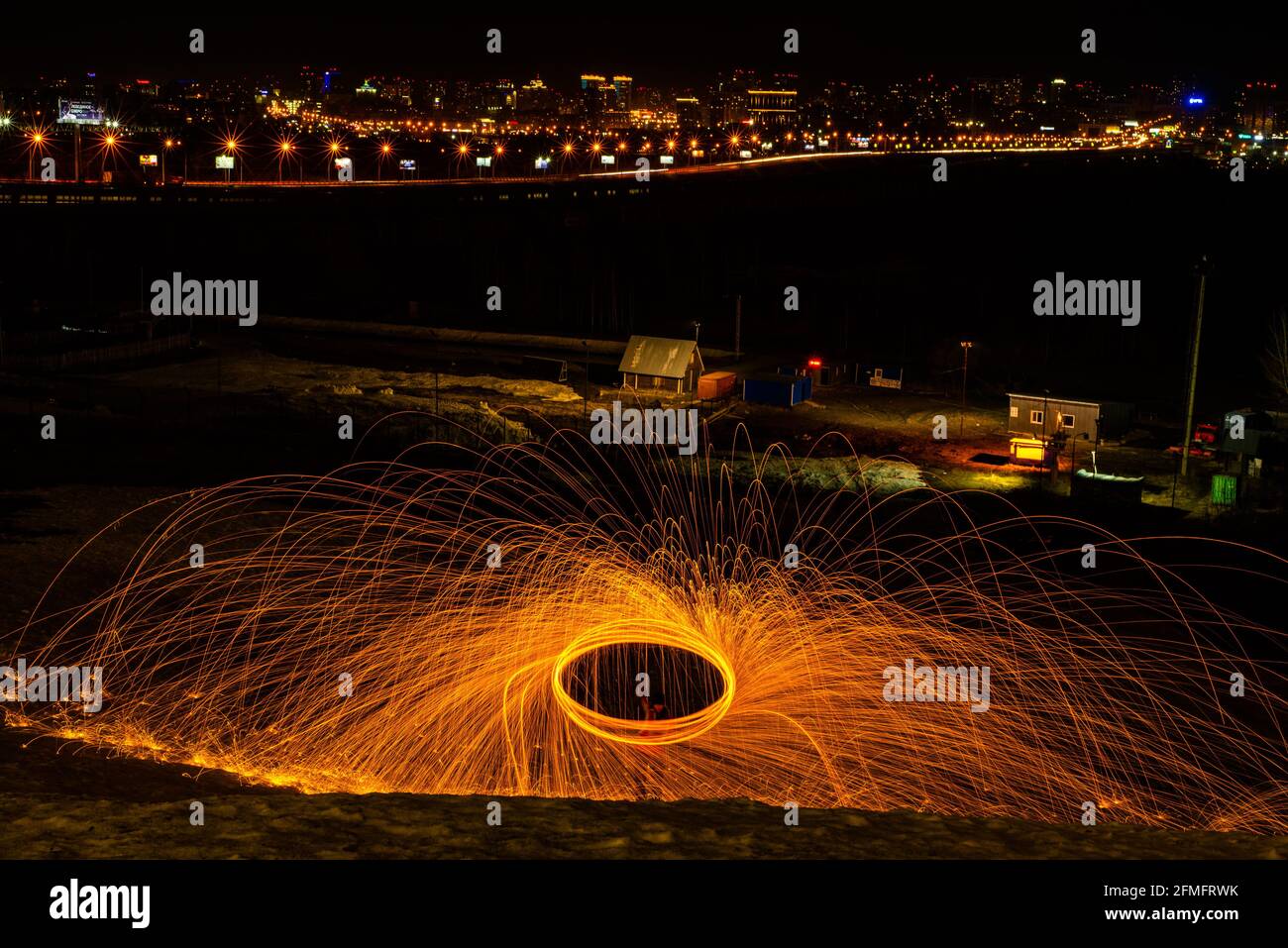 Large round burning fireworks sparkle from the burning steel wool. The