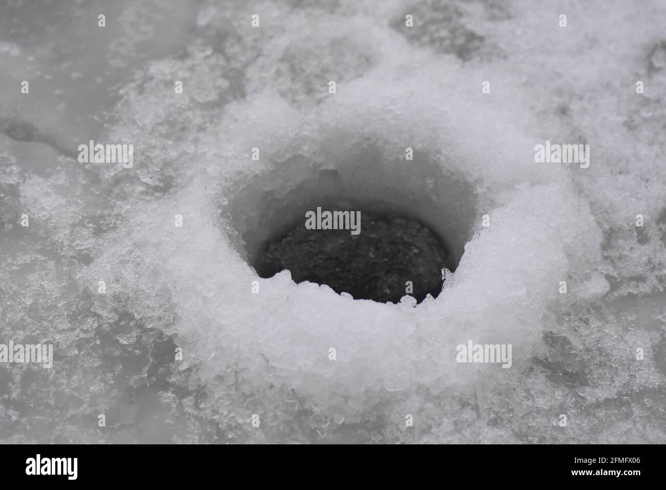 Fishing hole in ice Stock Photo Alamy