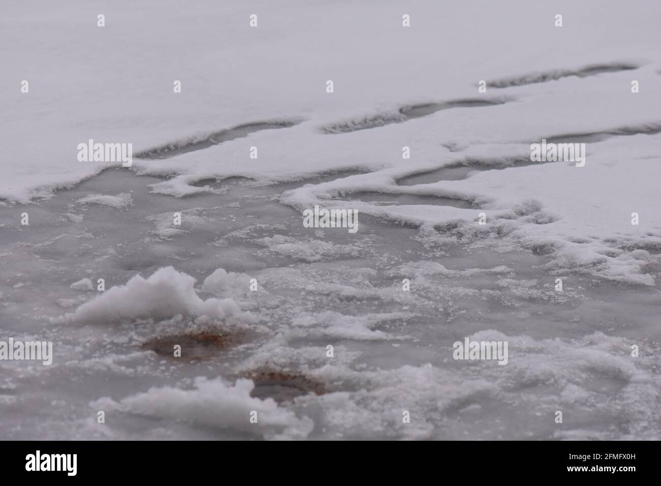 Fishing hole in ice Stock Photo