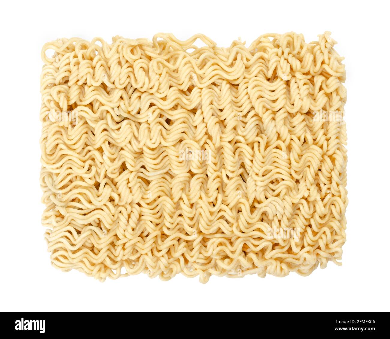Dried instant noodle block, from above. Instant ramen are noodles sold in precooked and dried block form,  to be soaked in boiling water. Stock Photo