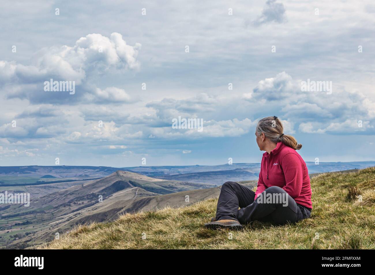 Female Hiker looking out towards Mam Tor Stock Photo