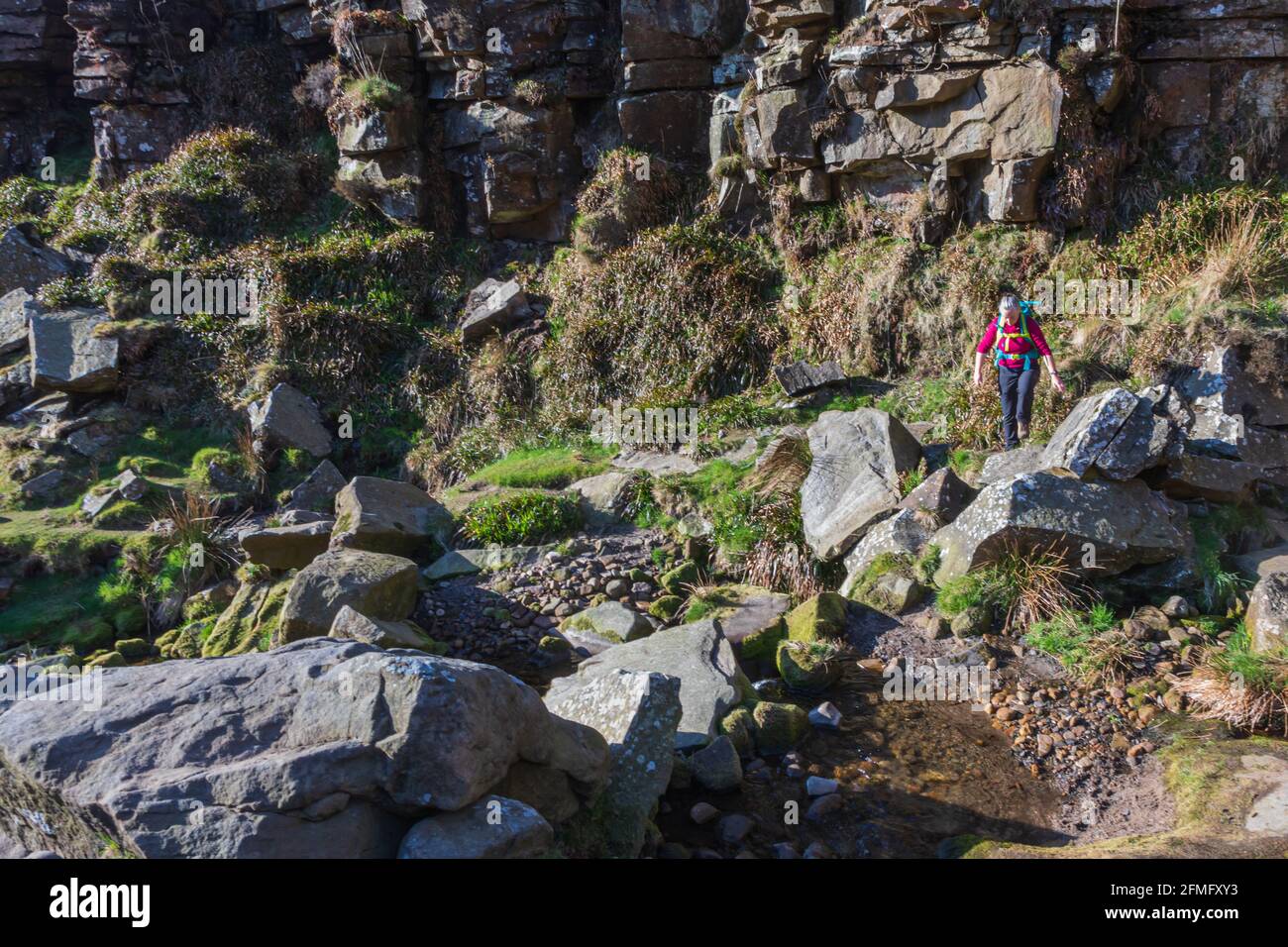 Hiker walking on rocks Stock Photo