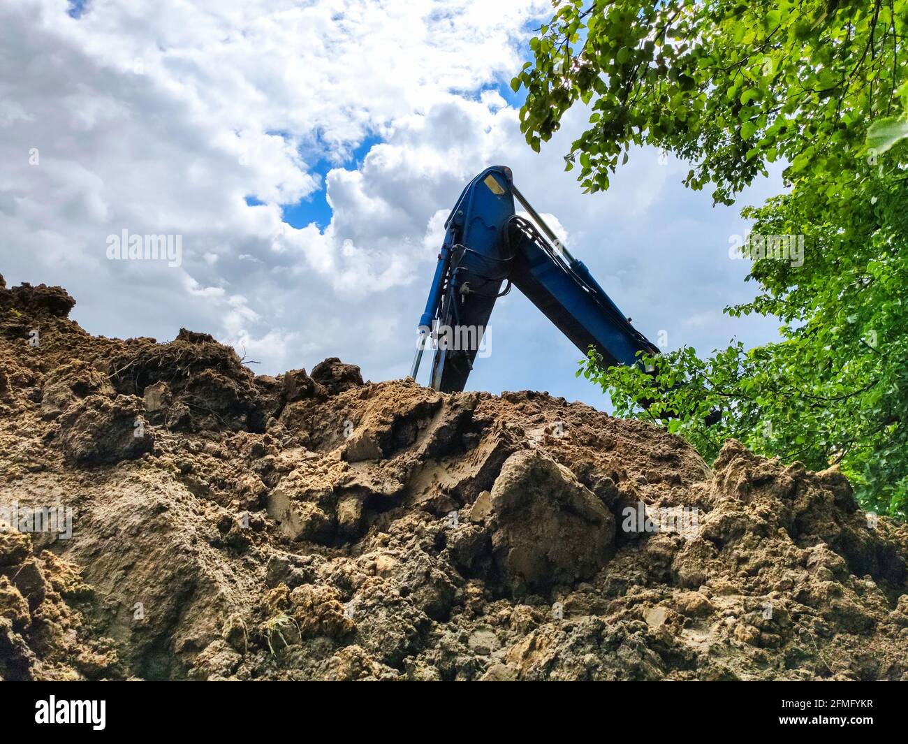 A work excavator digging a trench for the foundation of a building ...