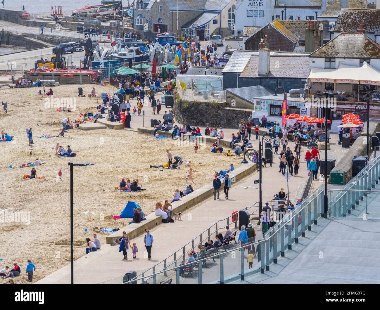 Lyme Regis, Dorset, UK. 9th May, 2021. UK Weather. Warm sunny spells at seaside resort of Lyme Regis. Visitors and locals enjoy the warm and sunny weather on Sunday. Credit: Celia McMahon/Alamy Live News Stock Photo