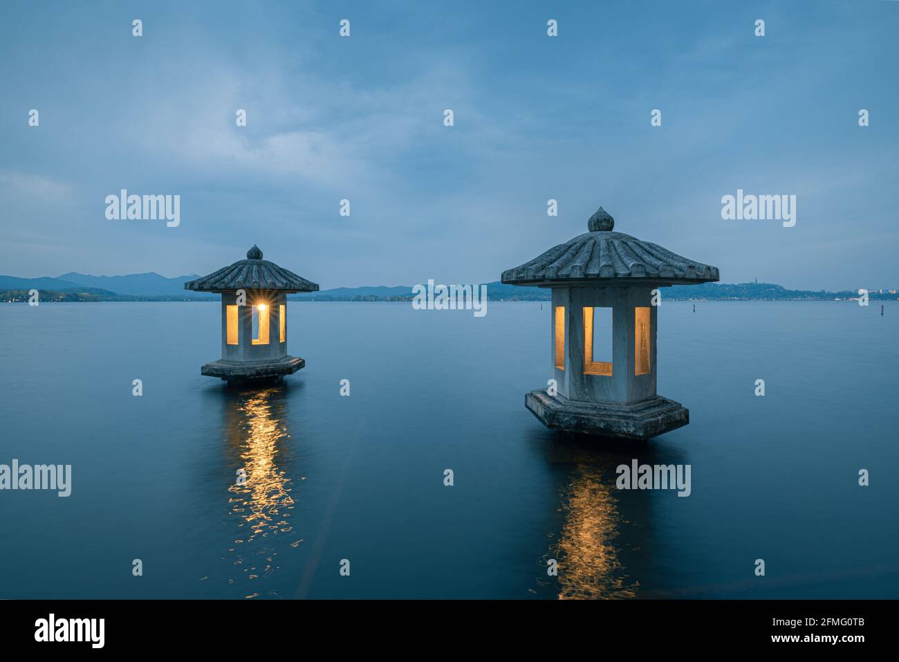 Night view of the beautiful landscape in West Lake in Hangzhou, with two stone lanterns in the lake Stock Photo