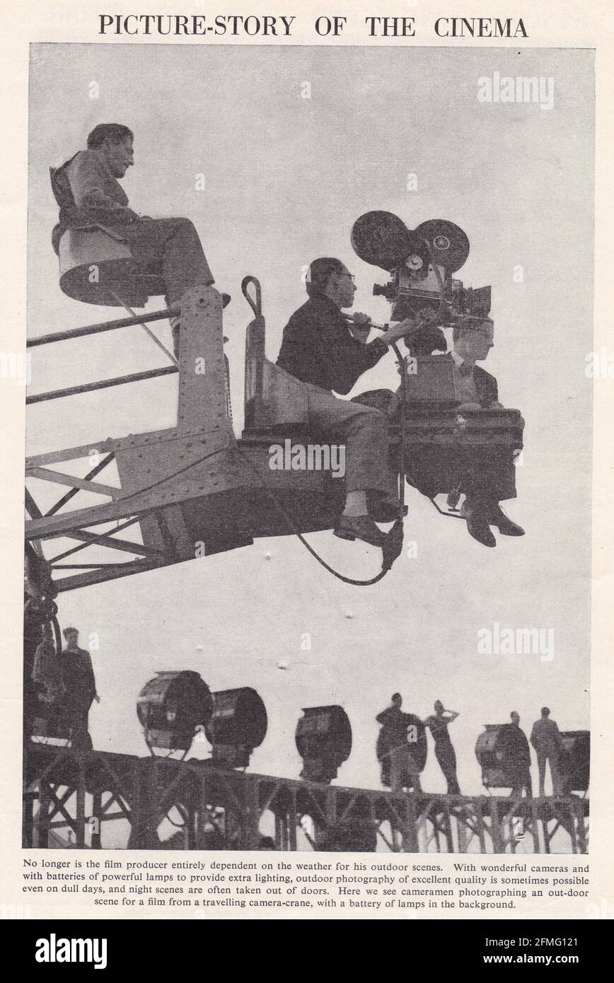 Vintage black and white photo of cameramen photographing an out-door scene for a film from a travelling camera-crane 1940s. Stock Photo