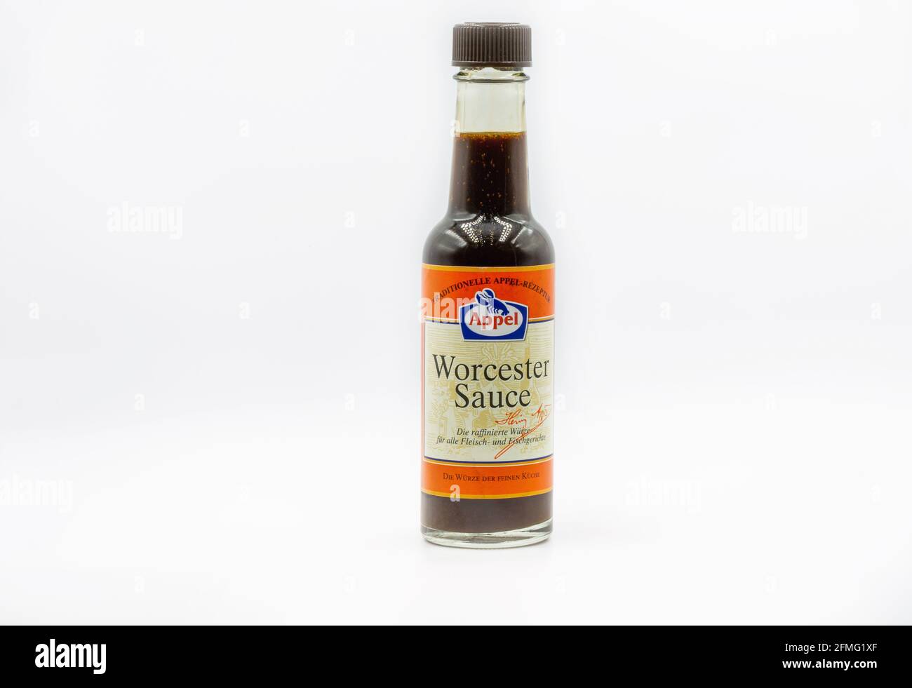 KYIV, UKRAINE - FEBRUARY 20, 2021: Studio shoot of Worcester sauce glass bottle closeup against white. It is frequently used to enhance food and drink Stock Photo