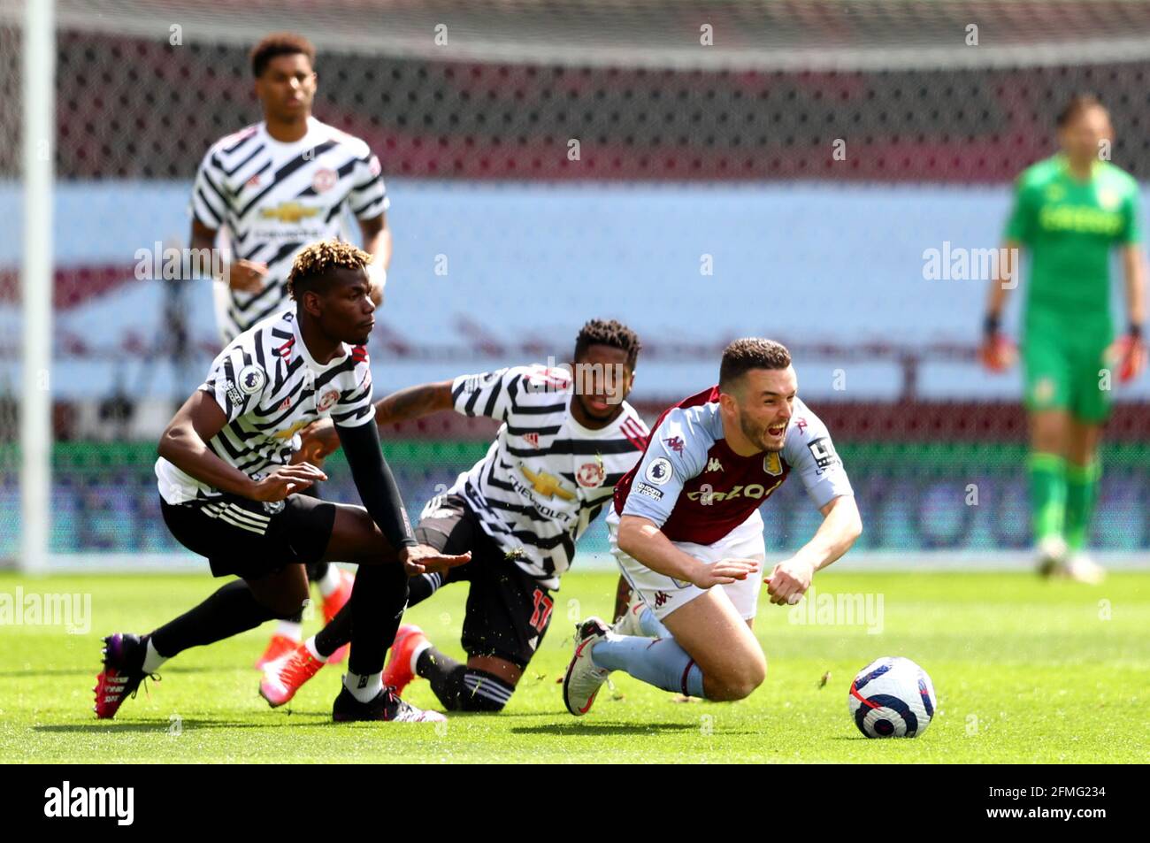 Aston Villa's John McGinn (right) and Manchester United's Paul Pogba (left) and Manchester United's Fred battle for the ball during the Premier League match at Villa Park, Birmingham. Picture date: Sunday May 9, 2021. Stock Photo