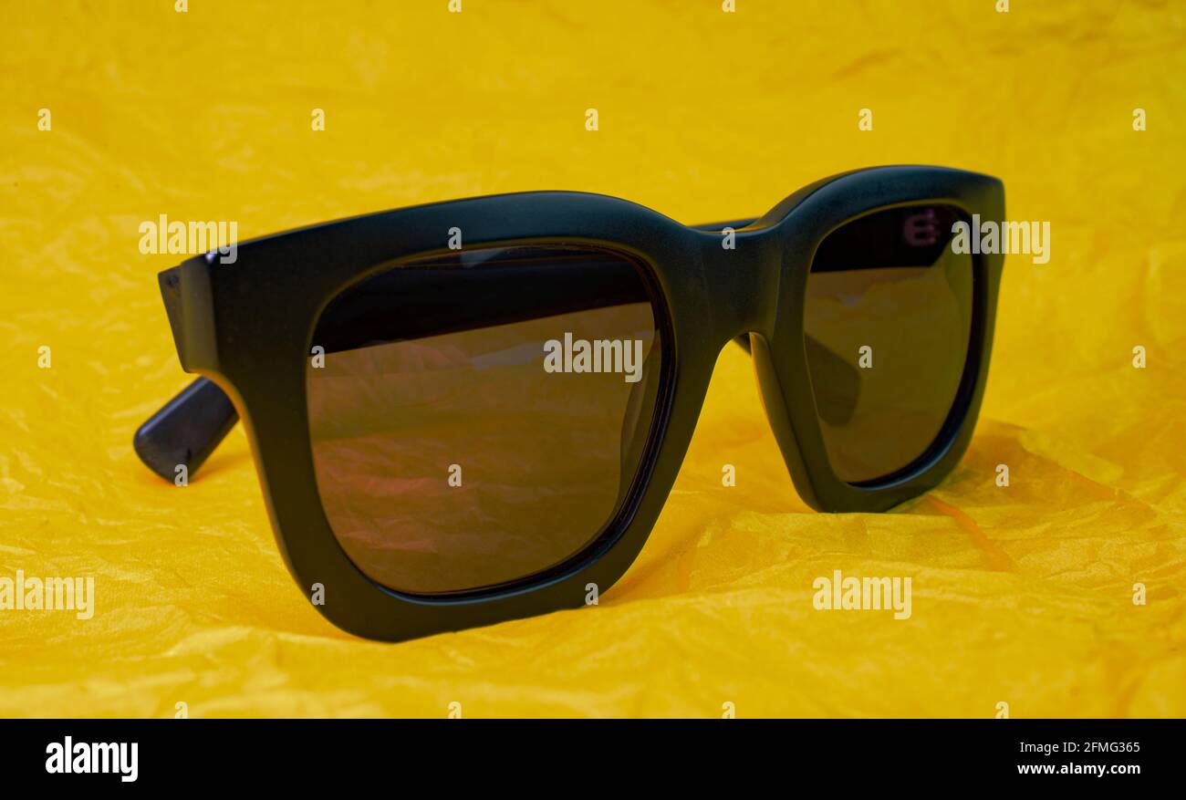 Cool sunglasses on a vibrant yellow background Stock Photo