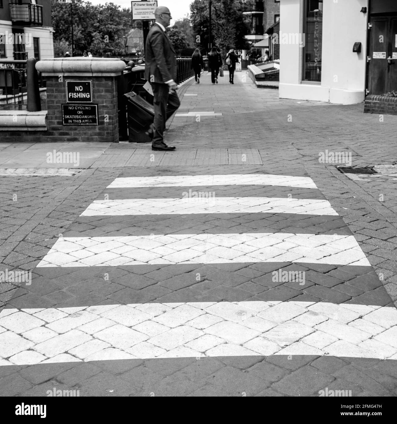 Kingston Upon Thames Surrey London UK May 07 2021,  Businessman Alone Walking Past A Pedestrian Or Zebra Road Crossing Stock Photo