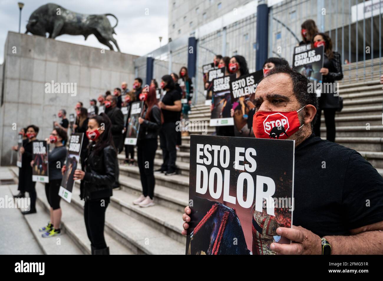 Animal rights activists carrying placards with bullfighting scenes during a protest against bullfighting as the bullfighting season starts in Madrid next week for San Isidro festivity. Animal rights group Anima Naturalis gathered to protest in Vista Alegre bullring of Madrid demanding the abolition of bullfighting, shouting slogans against animal cruelty and animal torture. The Bullfighting season will start next week with a maximum capacity of 40% and a maximum of 6,000 spectators due to healthcare measures to stop the spread of coronavirus. Stock Photo