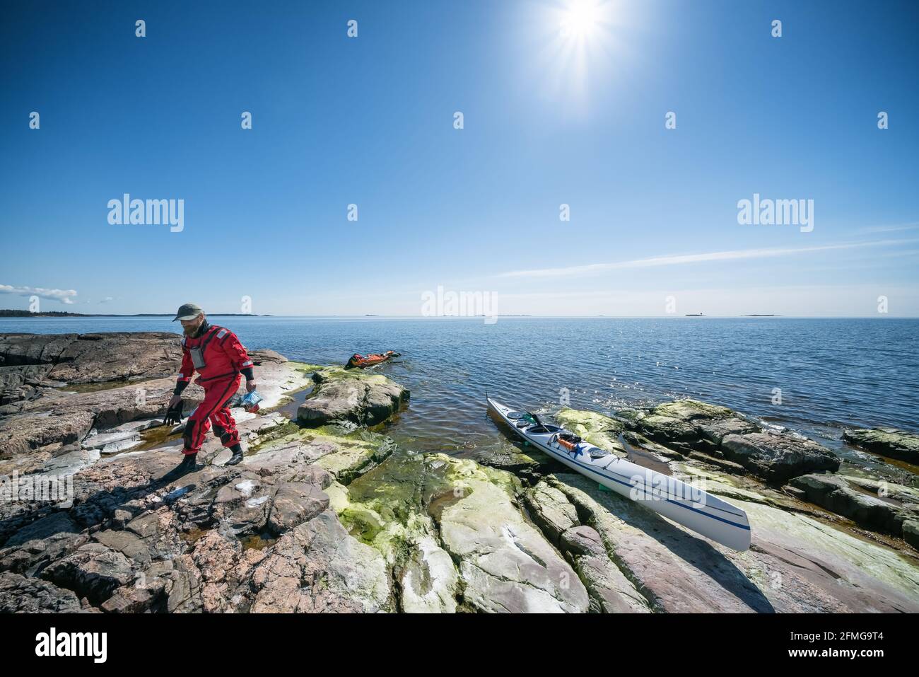 Taking a break from kayaking on Tallholmen island, Sipoo, Finland Stock Photo