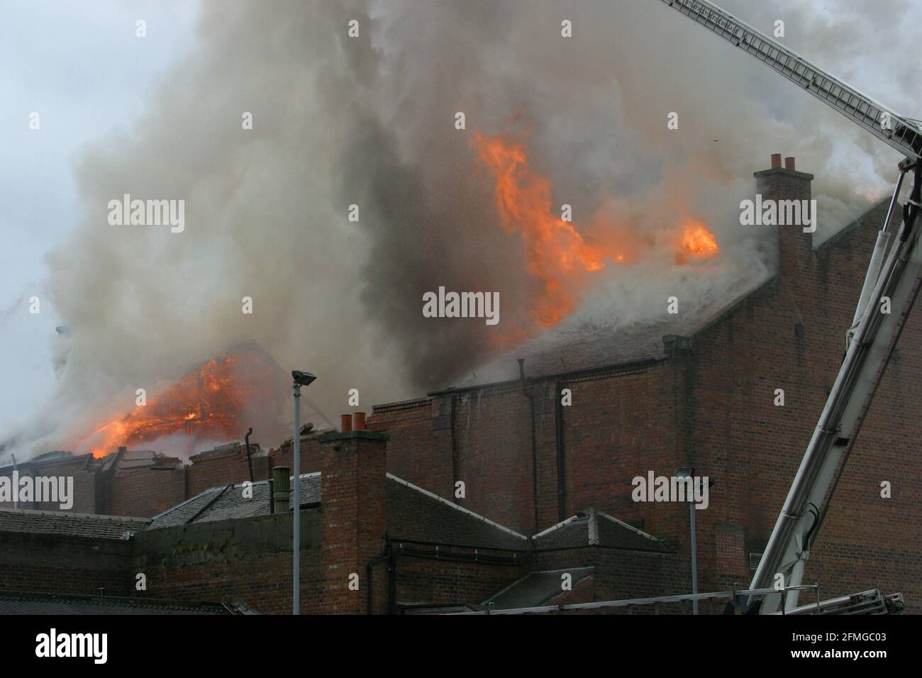 Burning building in Ayr, Ayrshire, Scotland, UK. Scottish Fire & rescue  Firefighters using  turntable ladder to fight fire in the roof of a burning building Stock Photo