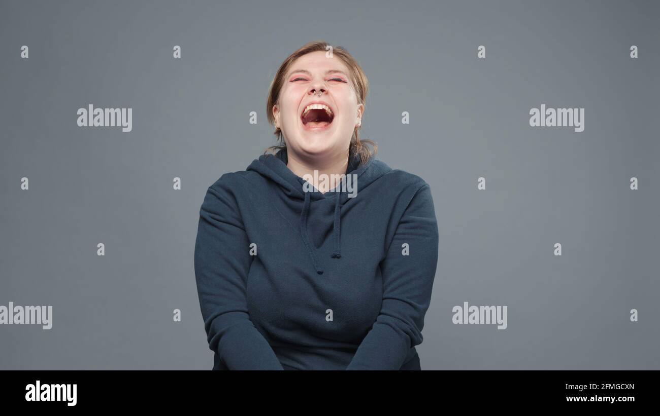 Photo of laughing stout woman in sweatshirt Stock Photo